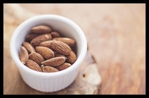 A small bowl of whole almonds. Eating a 1/4 cup gives you 7.5 grams of protein.